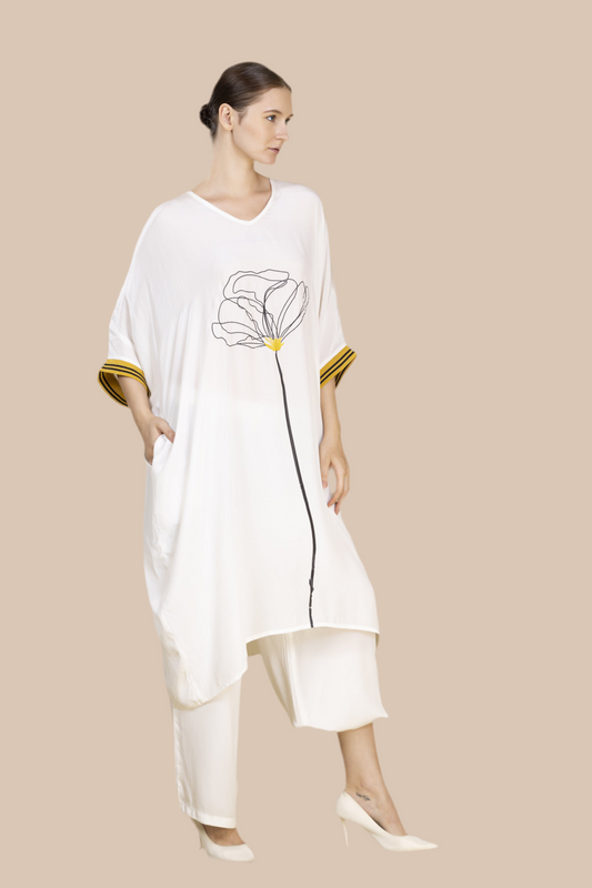 V neck White flow top in bamboo crepe with a wild peony print in the front in black & yellow. Cuffs in gold and black weave.