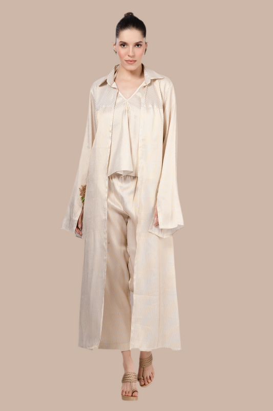 Cream and gold pinstripe jacket, top and pant.  Embroidered motif on cuffs.