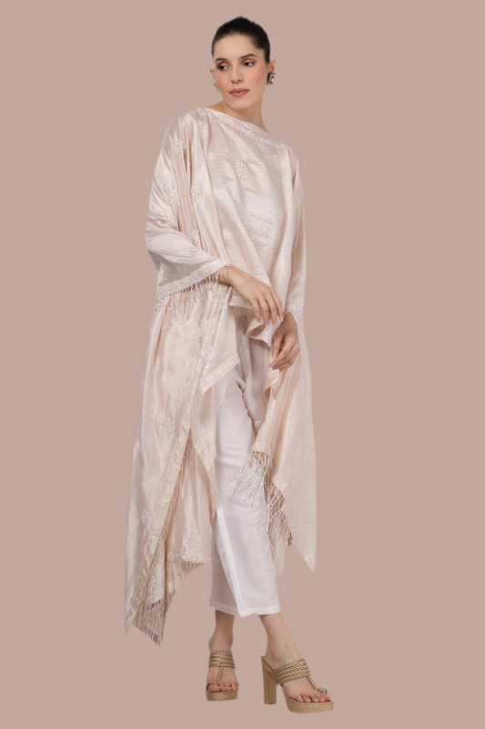 Light pinkish beige silk wrap / throw with all over Chikankari hand embroidery and finished with beaded tassels