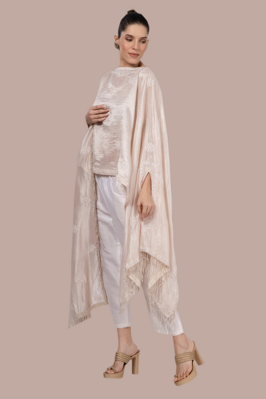 Light pinkish beige silk wrap / throw with all over Chikankari hand embroidery and finished with beaded tassels
