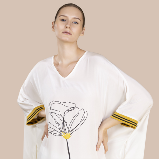 V neck White flow top in bamboo crepe with a wild peony print in the front in black & yellow. Cuffs in gold and black weave.